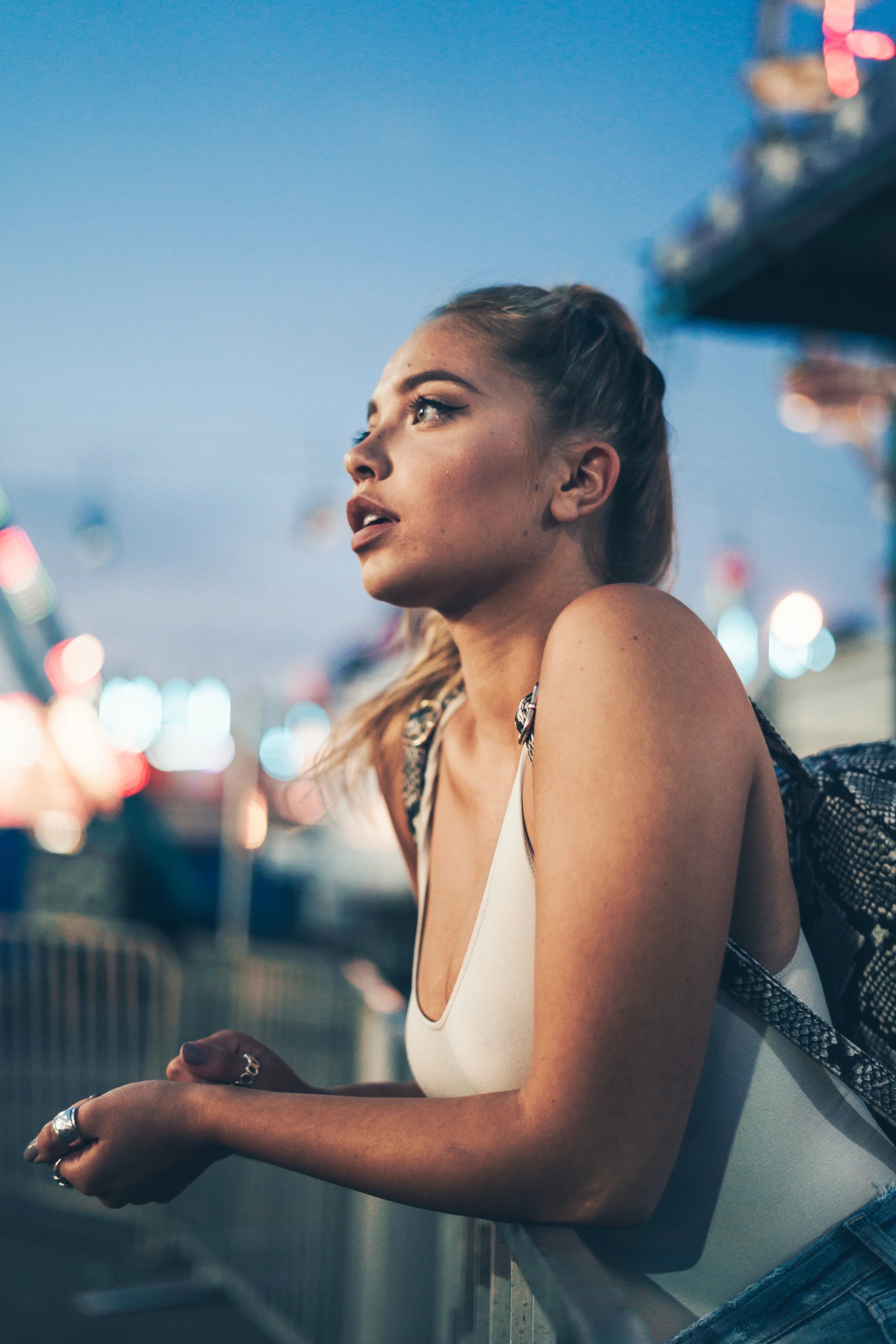 files/young-model-leans-on-fence.webp